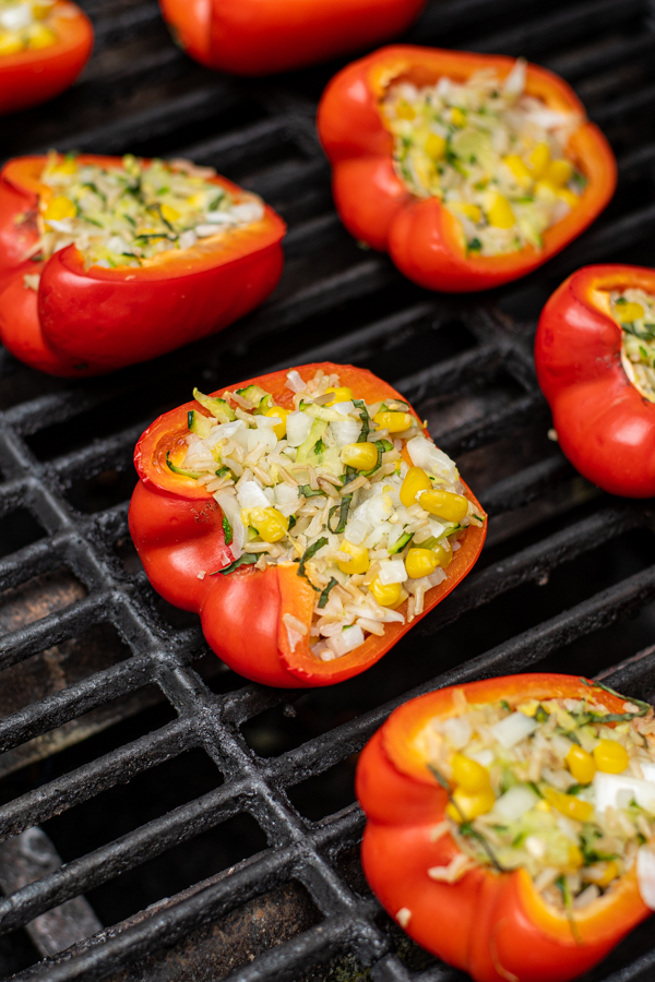 a stuffed red bell pepper on a grill grate