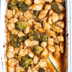 Pinterest Pin for Baked General Tso's Chicken showing a baking dish filled with saucy chicken and broccoli with a serving spoon