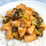 Pinterest Pin for Baked General Tso's Chicken showing a plate full of steamed rice topped with saucy chicken and broccoli