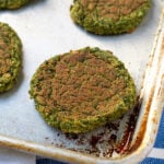 Pinterest Pin for Oven Baked Falafel showing a sheet pan with a close up of a baked falafel