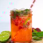 Pinterest Pin for Strawberry Mojito Mocktail showing an image of a glass filled with pink mocktail garnished with fresh mint and lime slices