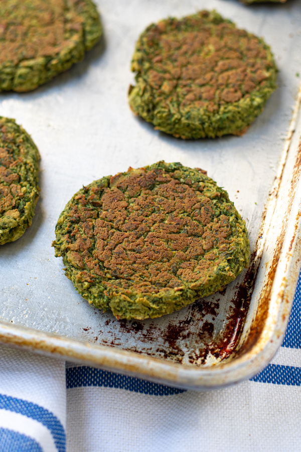 close up a a patty of baked falafel on a sheet pan
