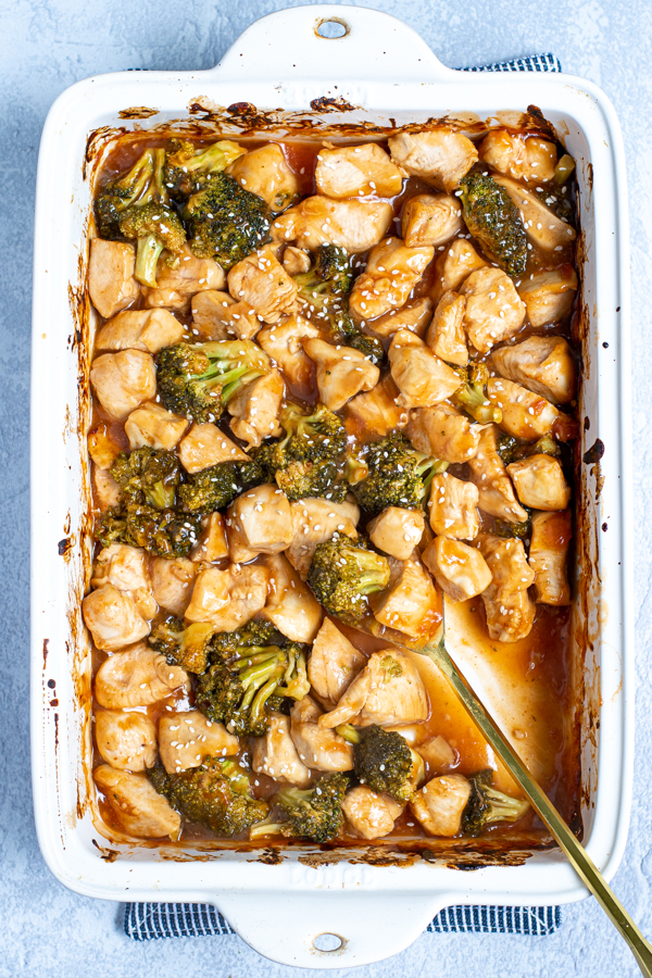 overhead view of a baking dish with general tso chicken and broccoli