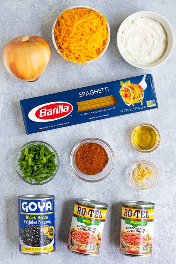 all of the ingredients needed to make one-pot taco spaghetti laid out on a marble surface