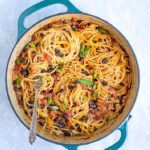 Pinterest Pin for One-Pot Taco Spaghetti with image of a pot of cooked taco spaghetti with black beans, tomatoes, cheese, and green onions