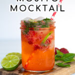 Pinterest Pin for Strawberry Mojito Mocktail showing a glass with strawberries, mint, limes, and ice sitting on a wood cutting board