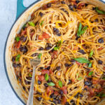 Pinterest Pin for One-Pot Taco Spaghetti with image of teal pot filled with taco spaghetti garnished with cheese and green onions