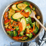 Pinterest Pin for Easy Veggie Stir Fry with a photo of a skillet filled with colorful vegetables in a sauce