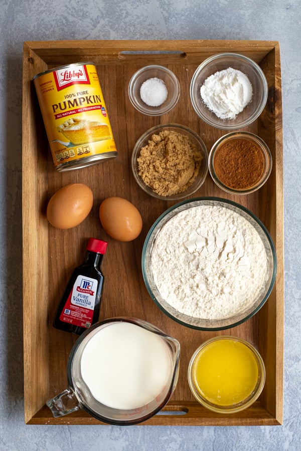 All of the ingredients needed to make pumpkin pancakes from scratch including pumpkin puree and pumpkin pie spice blend.