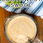Pinterest Pin with text overlay Healthy Southwest Sauce showing photo of a measuring cup filled with sauce with a spoon resting in the sauce.
