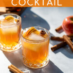 Pinterest Pin with text overlay Apple Cider Bourbon Cocktail, image of whiskey glass full of bourbon cider garnished with cinnamon sticks and apple slices.