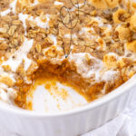 Pinterest Pin with Text: Sweet Potato Casserole, showing white casserole dish with scoop taken out of the sweet potato casserole.