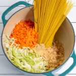 Pinterest Pin with text, One-Pot Teriyaki Noodles. Image of pot with ingredients needed for teriyaki noodles inside.