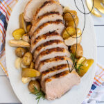 Pinterest Pin with Text, Pork Loin with Apples. Image showing sliced pork on serving platter.