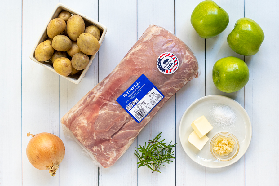 All the ingredients needed to make a roasted pork loin with apples.