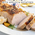 Pinterest Pin with Text, Pork Loin Roast with Apples & Potatoes. Image showing sliced pork on serving platter.