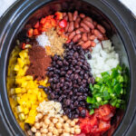 Pinterest Pin with text overlay, Crockpot 3-Bean Vegetarian Chili. Image of crockpot filled with the ingredients nicely laid out.