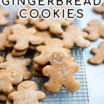 Pinterest Pin with text overlay, Glazed Gingerbread Cookies. Image of gingerbread cookies on a wire rack.