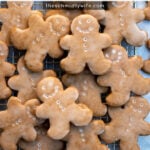 Pinterest Pin with text overlay, Soft Glazed Gingerbread Cookies. Image of gingerbread cookies on a wire rack.