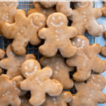 Pinterest Pin with text overlay, Glazed Gingerbread Cookies. Image of gingerbread cookies on a wire rack.