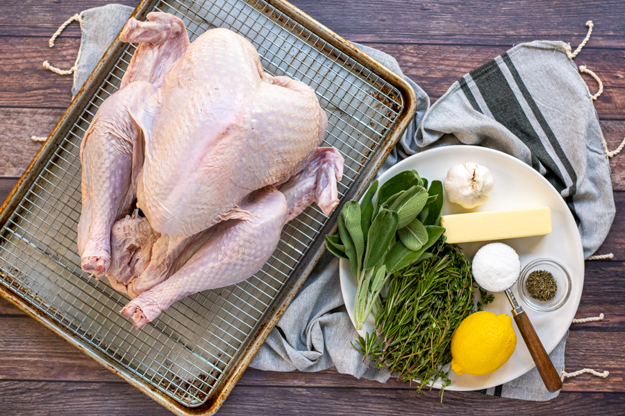 All the ingredients needed laid on a table for dry brining and roasting a turkey.