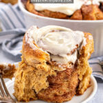 Pinterest Pin with text overlay 'Overnight Gingerbread Cinnamon Rolls'. Image of a gingerbread cinnamon roll on a small white plate.