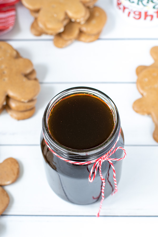 Close up of Gingerbread Syrup in a glass jar with a red and white string tied in a bow.