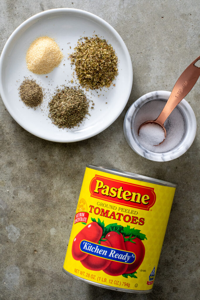 Ingredients needed to make pizza sauce including kitchen ready tomatoes, spices, and salt.