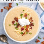 Pinterest Pin for with text overlay 'Instant Pot Loaded Baked Potato Soup'. Image of bowl of garnished baked potato soup.