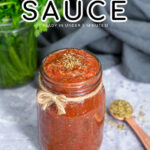 Pinterest pin with text overlay 'Pizza Sauce ready in under 5 minutes'. Image of sauce filled to the top in a glass jar.