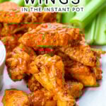 Pinterest Pin with text overlay 'Chicken Wings in the instant pot'. Image of platter with pile of saucy chicken wings.
