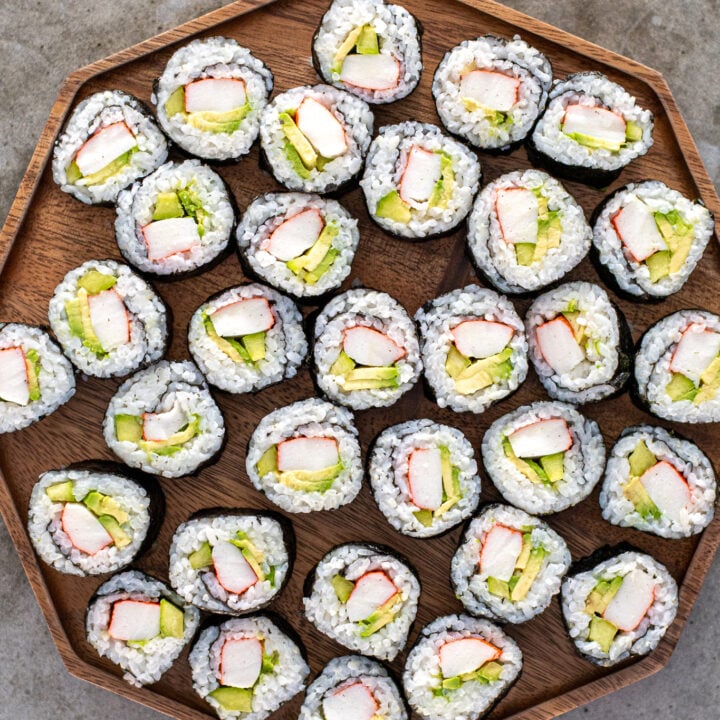 California rolls on a large wooden platter.