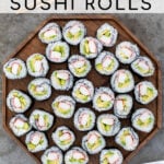 Pinterest Pin with text overlay 'Homemade California Sushi Rolls', image of large wood platter filled with sushi rolls.