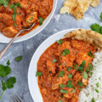 Pinterest Pin with text overlay 'Chicken Tikka Masala', image of bowl of chicken tikka masala next to a bed of rice.