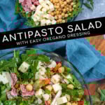 Pinterest Pin with text over lay 'Antipasto Salad with easy oregano dressing', image of a bowl of arugula topped with the ingredients of the salad.