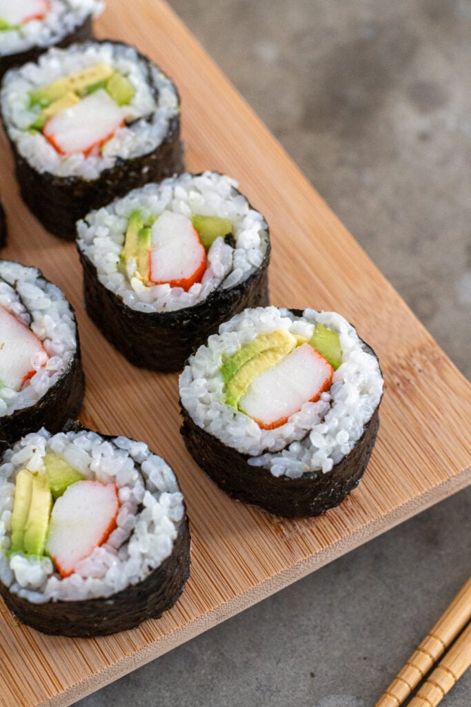 Close up of California roll Sushi on a bamboo platter.
