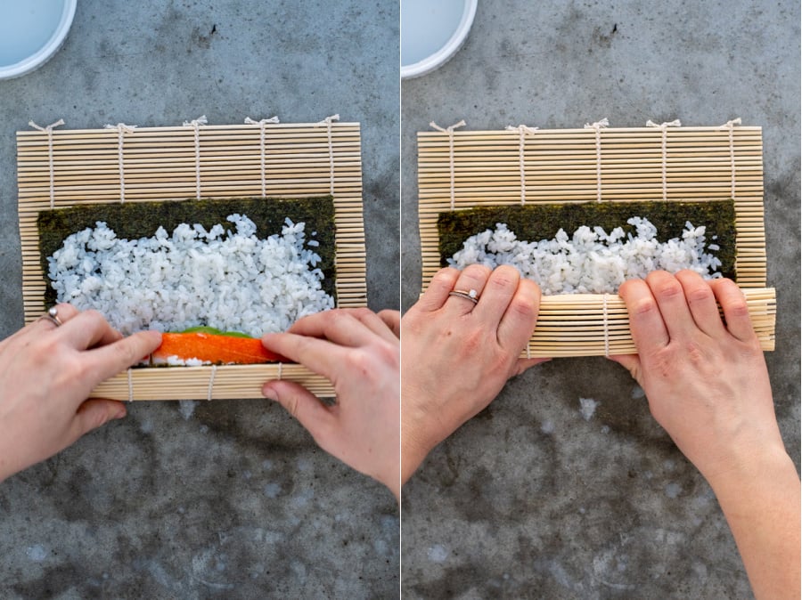 Step 5 of making California rolls rolling the sushi mat over the fillings to cover and pressing them snuggly together.