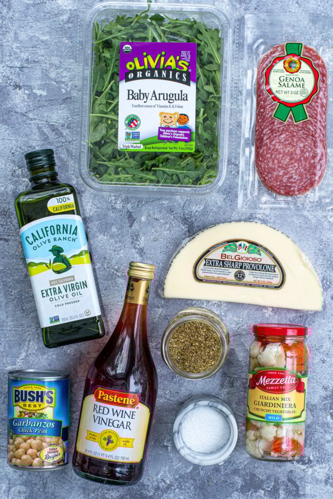 Ingredients for an easy antipasto salad laid out on a table top.