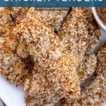 Pinterest Pin with text 'Pretzel Crusted Chicken Tenders', image of stack of chicken tenders on a plate next to honey mustard.
