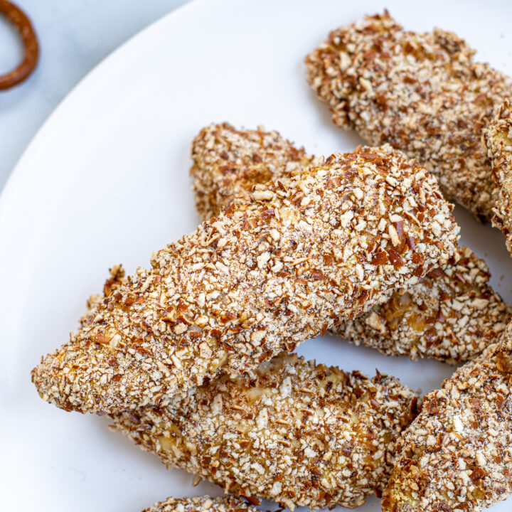 Close up of a single pretzel crusted chicken tender.