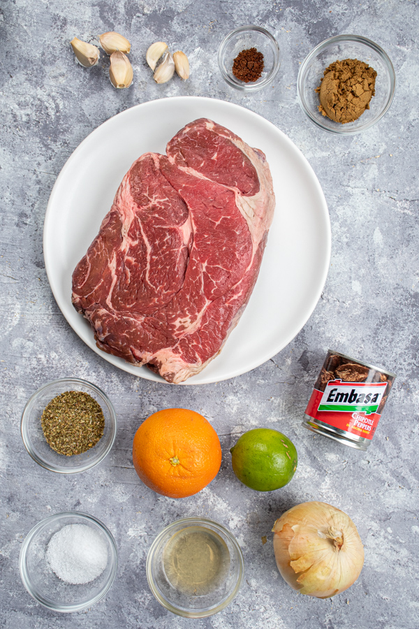 All the ingredients needed to make slow cooker barbacoa laid out on a table top.