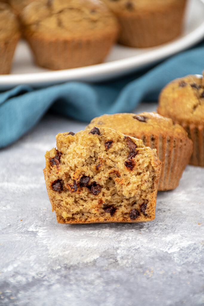 Inside of a flourless blender bababan muffin showing off a fluffy and tender inside with mini chocolate chips.