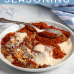 Pinterest Pin with text 'Fajita Seasoning', image of a plate of spices mixed together with a spoon.