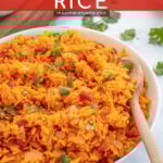 Pinterest Pin with overlay 'Mexican Rice' image of a large white bowl filled with mexican rice and garnished with cilantro.