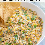 Pinterest Pin with text 'Mexican Street Corn Dip', image of street corn dip in a white bowl with tortilla chips.
