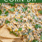 Pinterest Pin with text 'Mexican Street Corn Dip', image of street corn dip in a white bowl with tortilla chips.