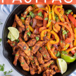 Pinterest Pin with text 'Skillet Chicken Fajitas', image of a cast iron filled with chicken and brightly colored bell peppers.
