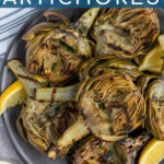 Pinterest Pin with text 'Grilled Artichokes', image of a close up of half an artichoke with perfect charred grill marks.