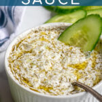 Pinterest Pin with text overlay 'Tzatziki Sauce', image of small white bowl filled with homemade tzatziki sauce.