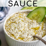 Pinterest Pin with text overlay 'the best homemade Tzatziki Sauce', image of small white bowl filled with homemade tzatziki sauce.